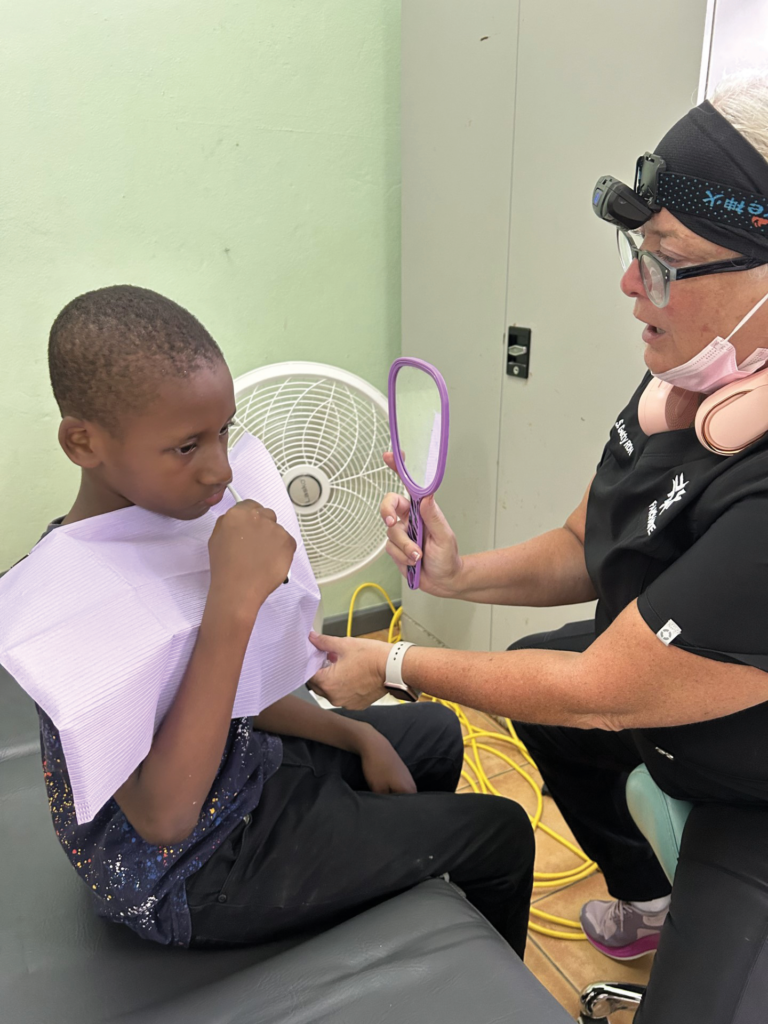 Hygienist Shelley Getty teaching brushing at Seal Grenada.